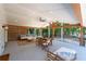 Inviting covered patio with wooden beam accents, dining area and lounge seating at 6160 Lake Lanier Heights Rd, Buford, GA 30518