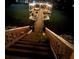 Illuminated dock features a long walkway on the water at night at 6160 Lake Lanier Heights Rd, Buford, GA 30518