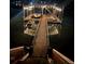 Picturesque dock featuring a boat and jet ski on a peaceful lake at night at 6160 Lake Lanier Heights Rd, Buford, GA 30518