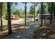 Lakeside homes with decks nestled among trees along a scenic driveway, offering privacy and charm at 6160 Lake Lanier Heights Rd, Buford, GA 30518