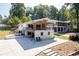 Charming home features a patio with seating for lake views and outdoor enjoyment at 6160 Lake Lanier Heights Rd, Buford, GA 30518