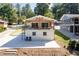 Charming home with a white brick exterior and a spacious covered patio overlooking the yard at 6160 Lake Lanier Heights Rd, Buford, GA 30518