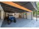 Covered garage area featuring golf cart and garage door with access to the backyard at 6160 Lake Lanier Heights Rd, Buford, GA 30518