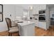 Bright kitchen with white cabinetry, stainless appliances, and breakfast bar with seating at 6160 Lake Lanier Heights Rd, Buford, GA 30518