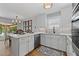 Bright, open kitchen with white cabinets, stainless steel appliances, and a marble countertop island at 6160 Lake Lanier Heights Rd, Buford, GA 30518