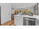 Beautiful kitchen with white cabinets, stainless steel appliances, and breakfast bar that opens to the living area at 6160 Lake Lanier Heights Rd, Buford, GA 30518