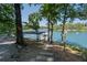 A charming walkway leading to the lake and boat dock, framed by lush trees at 6160 Lake Lanier Heights Rd, Buford, GA 30518