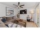 Comfortable living room featuring a large sectional sofa, modern decor, and sliding glass doors to covered patio at 6160 Lake Lanier Heights Rd, Buford, GA 30518