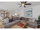 Comfortable living room featuring a large sectional sofa, modern decor, and access to the kitchen at 6160 Lake Lanier Heights Rd, Buford, GA 30518
