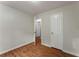 Bedroom with hardwood floors featuring white walls and a large closet at 700 Thomasville Se Blvd, Atlanta, GA 30315