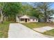 Charming single-story home featuring a well-manicured lawn and long concrete driveway at 700 Thomasville Se Blvd, Atlanta, GA 30315