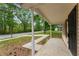 Covered front porch with white pillars and view of the front yard and street at 700 Thomasville Se Blvd, Atlanta, GA 30315