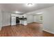 Cozy kitchen featuring white cabinets, stainless steel appliances, and laminate floors at 700 Thomasville Se Blvd, Atlanta, GA 30315