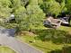 Aerial view showcasing a home with a large yard, mature trees, and neighborhood streets at 1643 Cumberland Trce, Acworth, GA 30102