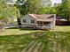 Charming home with a well-maintained lawn, flowering shrubs, and inviting front porch at 1643 Cumberland Trce, Acworth, GA 30102