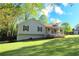 Charming single-Gathering home with a welcoming front porch, well-manicured lawn, and mature trees at 1643 Cumberland Trce, Acworth, GA 30102