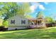 Charming ranch-style home featuring a cozy front porch, lush lawn and colorful flowerbeds at 1643 Cumberland Trce, Acworth, GA 30102