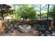 Deck with fire pit, outdoor chairs, and wood fence, surrounded by mature trees for the perfect private backyard at 1643 Cumberland Trce, Acworth, GA 30102