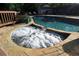 Inviting hot tub with bubbling water, surrounded by a stone patio and overlooking the pool at 1643 Cumberland Trce, Acworth, GA 30102