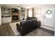 Cozy living room boasts a stone fireplace, built-in shelving, and a comfortable leather sofa at 1643 Cumberland Trce, Acworth, GA 30102