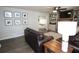 Inviting living room with a stone fireplace, built-in shelves, and an open view to the dining area at 1643 Cumberland Trce, Acworth, GA 30102