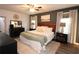 Spacious main bedroom featuring a ceiling fan, modern dark furniture, king bed and luxury decor at 1643 Cumberland Trce, Acworth, GA 30102