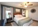 Spacious main bedroom featuring a ceiling fan, modern dark furniture, king bed and luxury decor at 1643 Cumberland Trce, Acworth, GA 30102