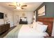 Spacious main bedroom featuring a ceiling fan, modern dark furniture, king bed and luxury decor at 1643 Cumberland Trce, Acworth, GA 30102