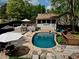 Inviting backyard pool with stone surround, wooden deck, outdoor seating and partially covered patio at 1643 Cumberland Trce, Acworth, GA 30102