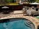 Inviting backyard pool with stone patio, tiered deck, and outdoor seating area at 1643 Cumberland Trce, Acworth, GA 30102