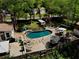 An aerial view of a beautiful pool and patio surrounded by lush greenery and comfortable outdoor seating at 1643 Cumberland Trce, Acworth, GA 30102