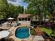 Inviting backyard pool with stone surround, wooden deck, outdoor seating and partially covered patio at 1643 Cumberland Trce, Acworth, GA 30102