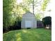 Backyard shed on a lush green lawn offering extra storage space at 1643 Cumberland Trce, Acworth, GA 30102