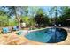 Outdoor swimming pool and lounge area, surrounded by lush landscaping and trees at 1643 Cumberland Trce, Acworth, GA 30102