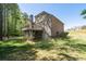 Rear exterior with a large yard, siding, deck, chimney and walkout basement at 2050 Heritage Green Dr, Marietta, GA 30064