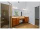 Bathroom featuring walk-in shower, double sinks, and a large mirror at 2050 Heritage Green Dr, Marietta, GA 30064