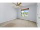 Bedroom with neutral carpet, light walls, ceiling fan, and view to exterior at 2050 Heritage Green Dr, Marietta, GA 30064