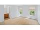 Bedroom with beige carpet, neutral walls, and two windows with roller shades at 2050 Heritage Green Dr, Marietta, GA 30064