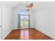 Bedroom with hardwood floors, neutral walls, and a large window with curtains at 2050 Heritage Green Dr, Marietta, GA 30064