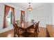 Elegant dining room featuring hardwood floors, paneled walls, and a stylish chandelier creating a warm and inviting atmosphere at 2050 Heritage Green Dr, Marietta, GA 30064