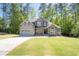 Charming two-story home with neutral siding, stone accents and an attached garage at 2050 Heritage Green Dr, Marietta, GA 30064