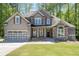 Charming two-story home with neutral siding, stone accents and an attached garage at 2050 Heritage Green Dr, Marietta, GA 30064