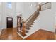 Grand foyer showcasing hardwood floors, an elegant staircase with iron railings, and abundant natural light at 2050 Heritage Green Dr, Marietta, GA 30064