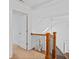 Hallway with wood and iron banister overlooking foyer, natural light from skylight at 2050 Heritage Green Dr, Marietta, GA 30064