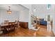Open-concept living area featuring hardwood floors, a vaulted ceiling, and a staircase leading to the second floor at 2050 Heritage Green Dr, Marietta, GA 30064