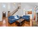 Inviting living room featuring hardwood floors, comfortable seating, a fireplace, and easy access to the kitchen at 2050 Heritage Green Dr, Marietta, GA 30064