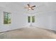 Spacious main bedroom featuring carpet flooring, a ceiling fan, and ample natural light at 2050 Heritage Green Dr, Marietta, GA 30064