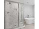 Bathroom boasting a glass-enclosed shower and a modern freestanding tub at 3205 Tackett Rd, Douglasville, GA 30135