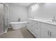 Bathroom featuring modern vanity, free standing tub, and glass shower at 3205 Tackett Rd, Douglasville, GA 30135
