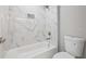 Tiled bathroom with tub, shower, and alcove creating an attractive and durable bathing space with neutral color palette at 3205 Tackett Rd, Douglasville, GA 30135
